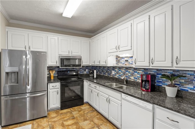 kitchen with backsplash, appliances with stainless steel finishes, a textured ceiling, white cabinetry, and a sink