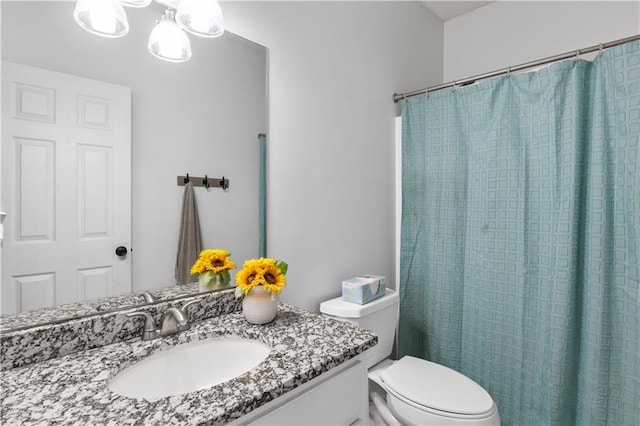 full bathroom with vanity, curtained shower, and toilet