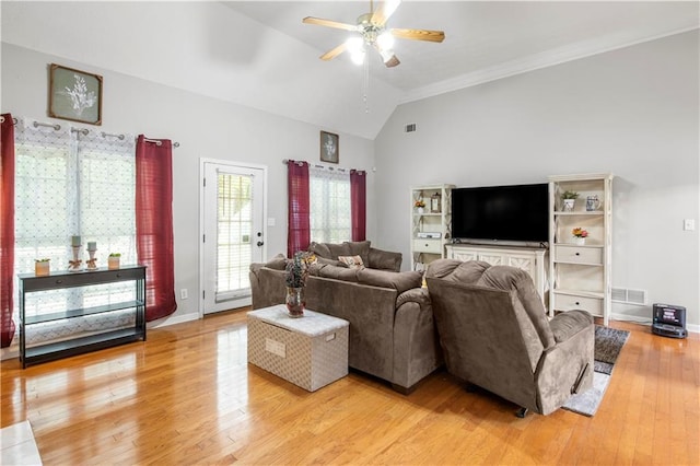 living area featuring light wood-type flooring, visible vents, baseboards, lofted ceiling, and ceiling fan