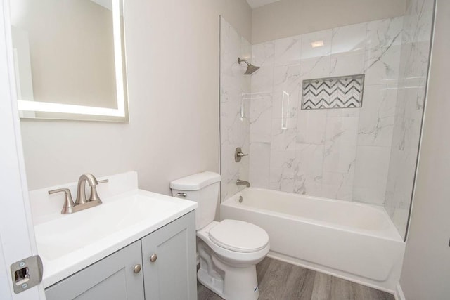 full bath featuring toilet, shower / bathtub combination, vanity, and wood finished floors