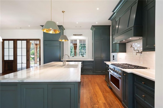 1830 Maple St, Carrollton, GA 30117 - kitchen with high end range, a sink, tasteful backsplash, wood finished floors, and custom exhaust hood