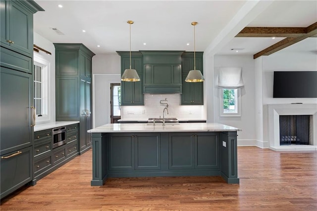 1830 Maple St, Carrollton, GA 30117 - kitchen with green cabinets, healthy amount of natural light, light wood-type flooring, recessed lighting, and beam ceiling