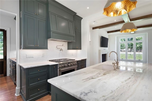1830 Maple St, Carrollton, GA 30117 - kitchen featuring a sink, stainless steel range, plenty of natural light, custom range hood, and beam ceiling