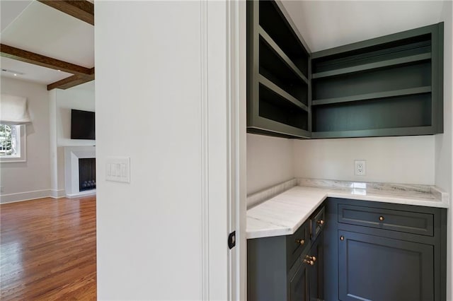 1830 Maple St, Carrollton, GA 30117 - kitchen with open shelves, wood finished floors, baseboards, beam ceiling, and gray cabinets