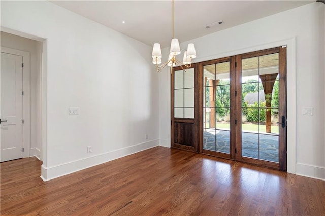 1830 Maple St, Carrollton, GA 30117 - unfurnished dining area with wood finished floors, a chandelier, and baseboards