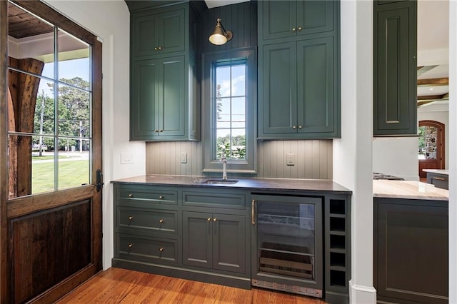 1830 Maple St, Carrollton, GA 30117 - bar featuring beverage cooler, a sink, and light wood-style floors