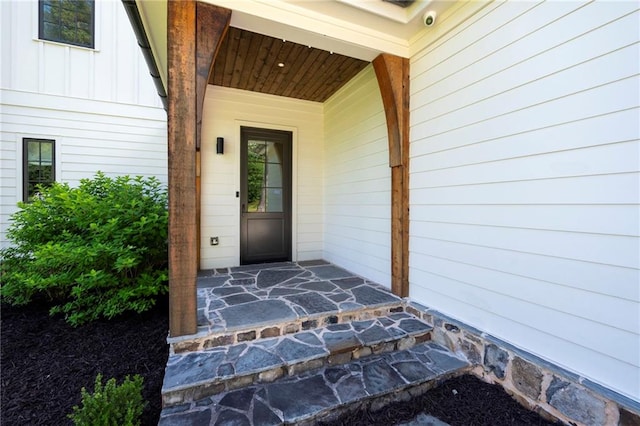 1830 Maple St, Carrollton, GA 30117 - property entrance with a security system, covered porch, and board and batten siding