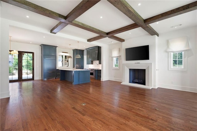1830 Maple St, Carrollton, GA 30117 - unfurnished living room with baseboards, beamed ceiling, a fireplace, a chandelier, and dark wood-style floors