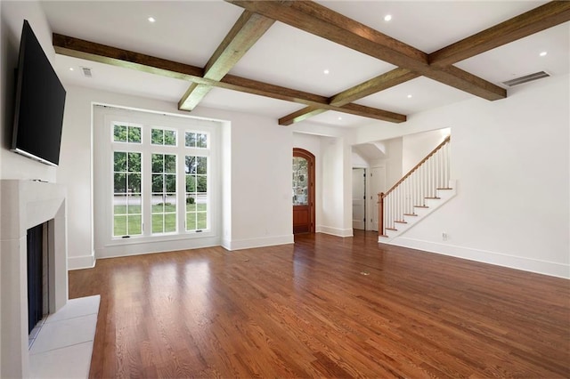 1830 Maple St, Carrollton, GA 30117 - unfurnished living room featuring coffered ceiling, arched walkways, wood finished floors, a fireplace with flush hearth, and baseboards