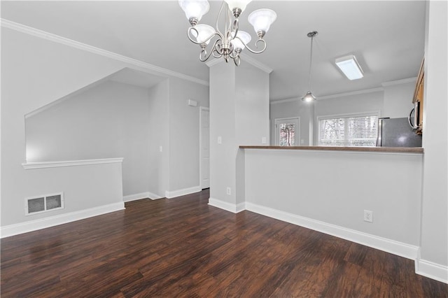 interior space with a notable chandelier, hardwood / wood-style floors, and crown molding