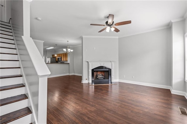 unfurnished living room with ceiling fan with notable chandelier, dark wood-type flooring, and ornamental molding