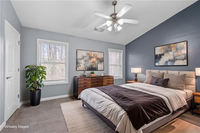 carpeted bedroom featuring vaulted ceiling and ceiling fan