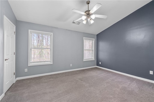 carpeted spare room featuring lofted ceiling and ceiling fan