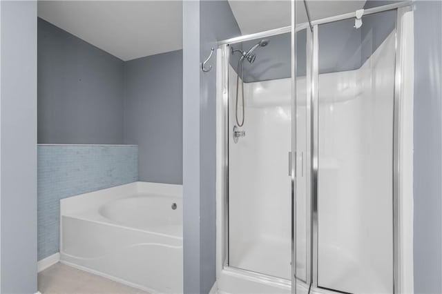 bathroom featuring separate shower and tub