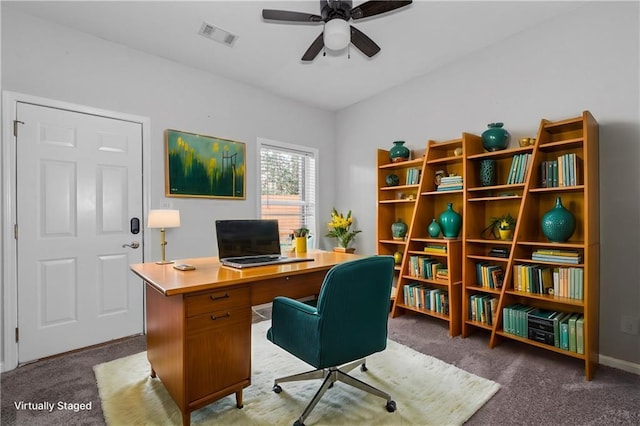 carpeted office space with ceiling fan