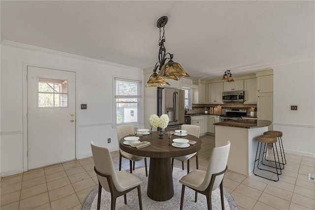 tiled dining space featuring ornamental molding