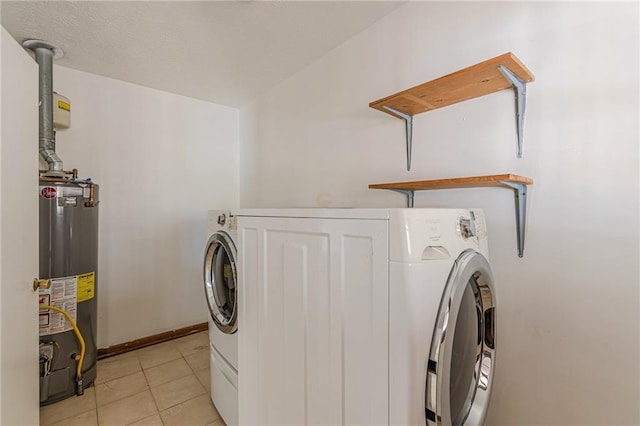 laundry area with washer / clothes dryer, gas water heater, and light tile patterned flooring