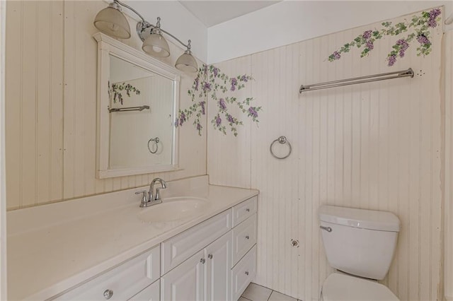 bathroom with vanity, tile patterned flooring, and toilet