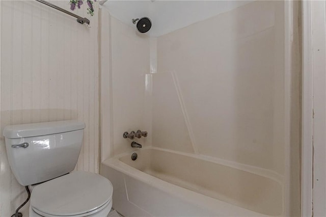 bathroom with bathtub / shower combination and toilet