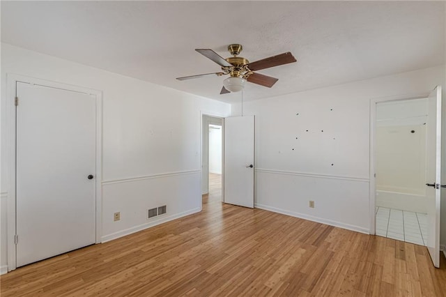 empty room with ceiling fan and light wood-type flooring