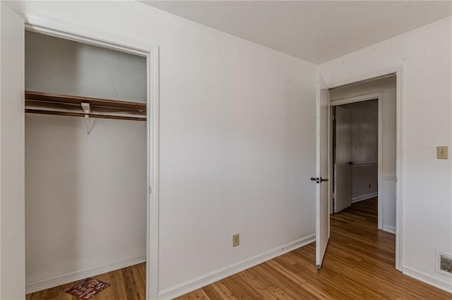 unfurnished bedroom featuring a closet and light hardwood / wood-style flooring