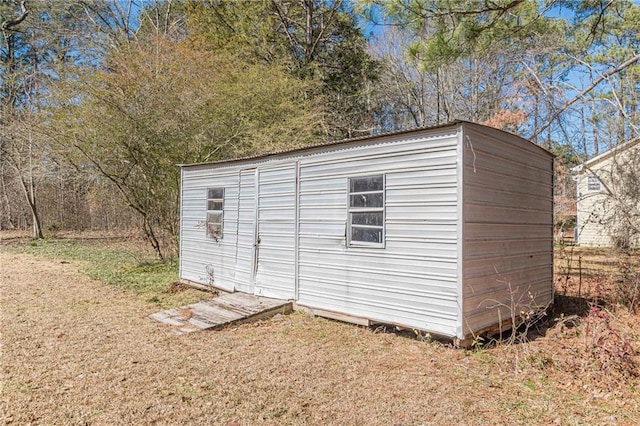 view of outbuilding featuring a lawn