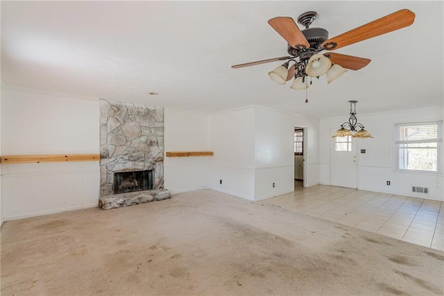 unfurnished living room with crown molding, light carpet, and a fireplace