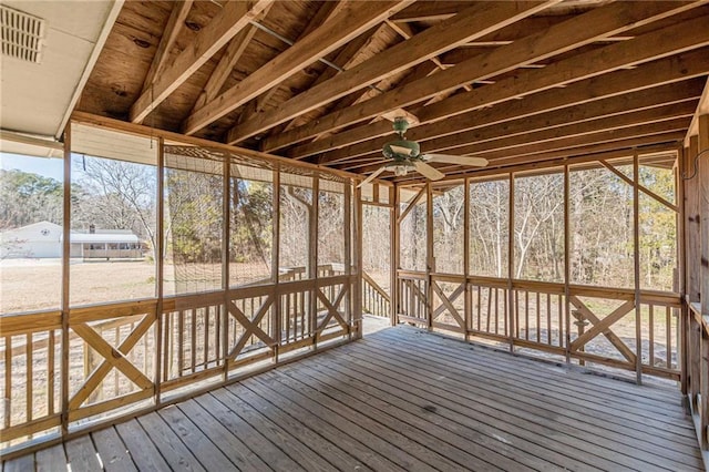 unfurnished sunroom with ceiling fan