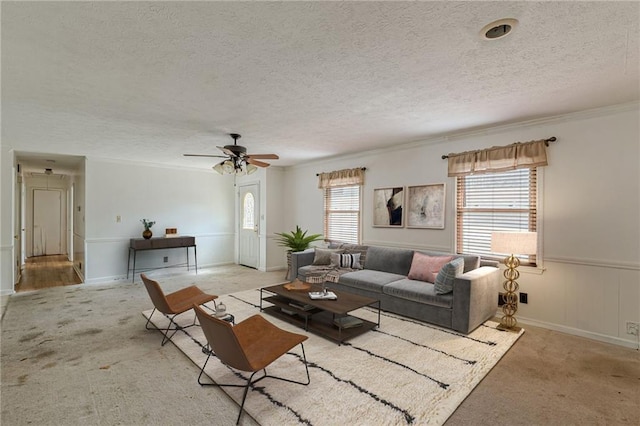 living room with a textured ceiling, light carpet, and a wealth of natural light