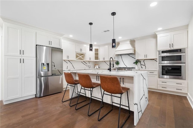 kitchen with dark hardwood / wood-style flooring, stainless steel appliances, white cabinetry, a center island, and custom range hood