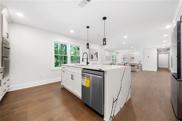 kitchen featuring a center island with sink, appliances with stainless steel finishes, white cabinets, sink, and dark wood-type flooring