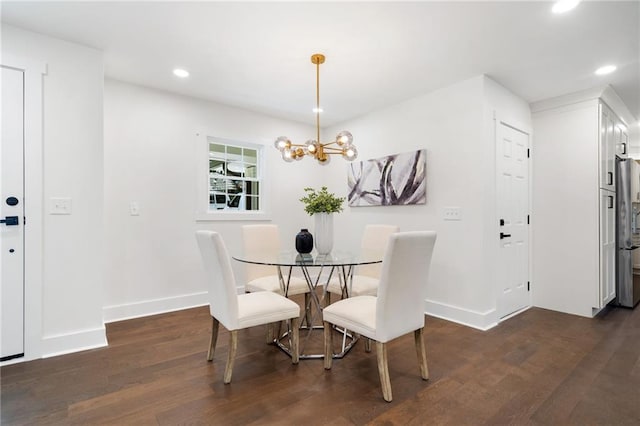 dining area with a notable chandelier and dark wood-type flooring