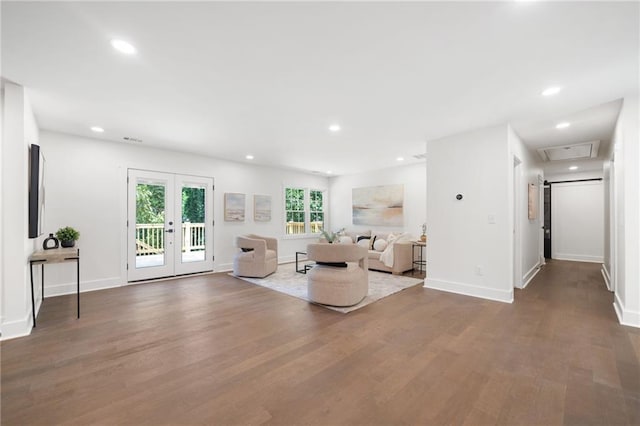 unfurnished living room featuring french doors, a barn door, and hardwood / wood-style floors