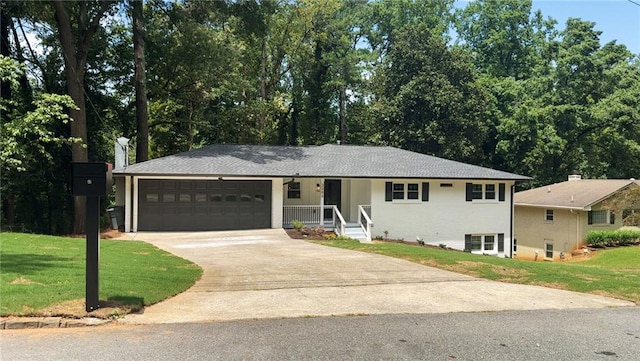 view of front of home with a front yard, a garage, and a porch