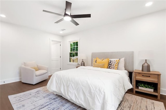 bedroom with ceiling fan and dark wood-type flooring