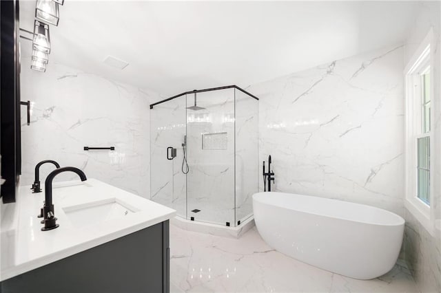 bathroom featuring tile walls, plus walk in shower, tile patterned floors, and vanity