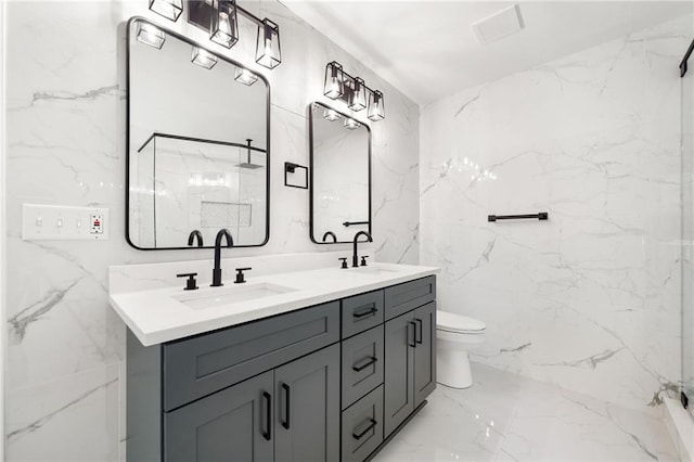 bathroom with tile patterned floors, tile walls, double sink vanity, and toilet