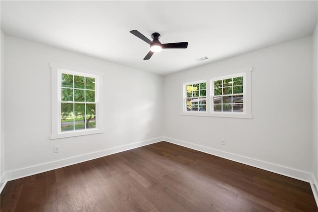 spare room featuring ceiling fan and dark hardwood / wood-style floors