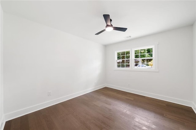 empty room featuring ceiling fan and dark wood-type flooring