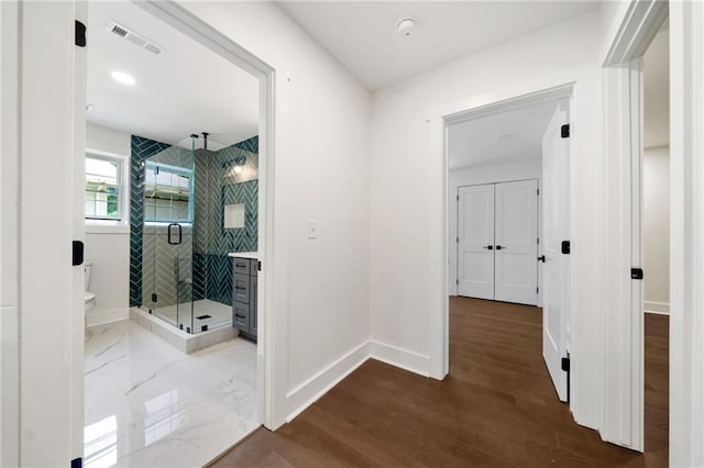 hallway featuring hardwood / wood-style flooring