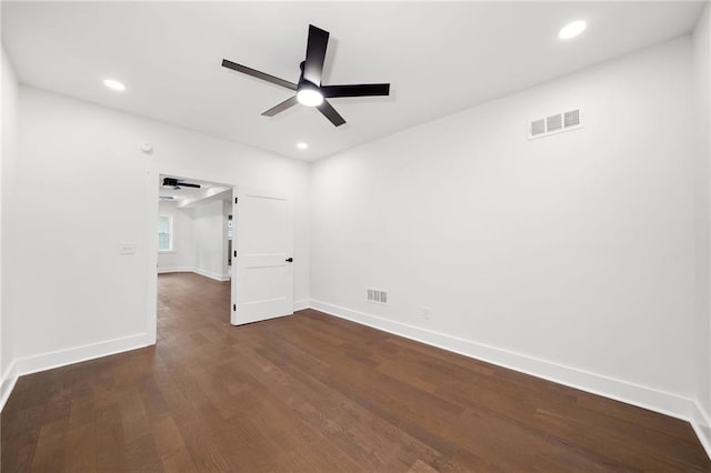 spare room with ceiling fan and dark wood-type flooring