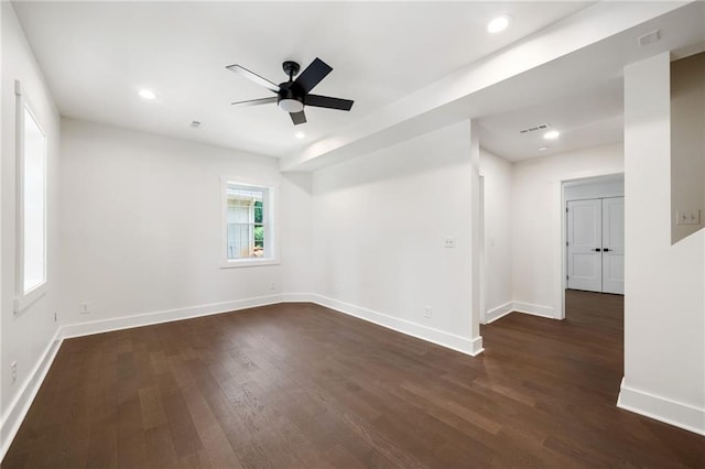 unfurnished room with dark wood-type flooring and ceiling fan