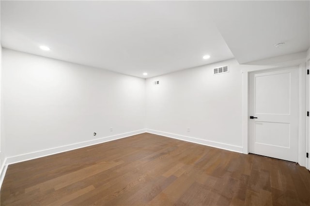 spare room with dark hardwood / wood-style flooring