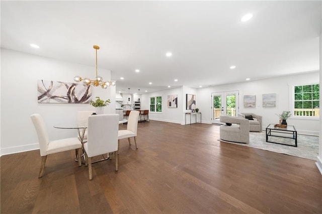 dining space featuring a notable chandelier and dark hardwood / wood-style floors