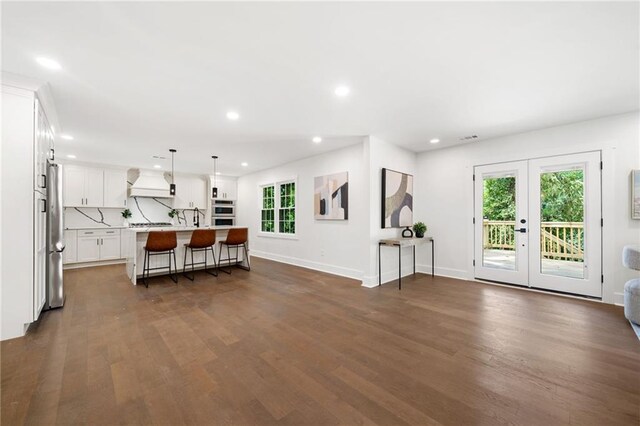 living room with french doors and dark wood-type flooring