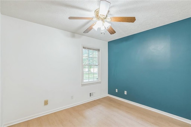 364 Stafford St SW, Marietta, GA 30064 - spare room featuring wood finished floors, a textured ceiling, and a ceiling fan