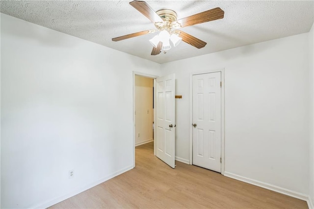 364 Stafford St SW, Marietta, GA 30064 - unfurnished bedroom with light wood-type flooring, a textured ceiling, and a ceiling fan