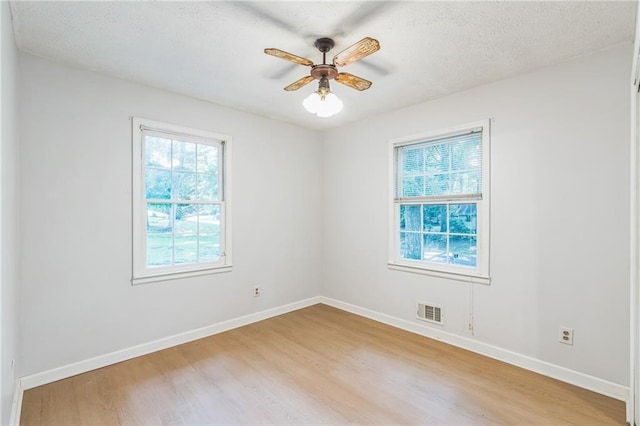 364 Stafford St SW, Marietta, GA 30064 - empty room with healthy amount of natural light, light wood finished floors, a ceiling fan, and a textured ceiling