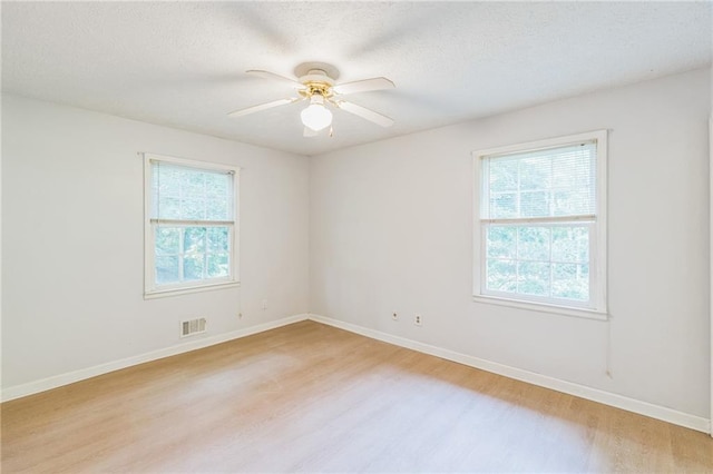364 Stafford St SW, Marietta, GA 30064 - empty room with light wood-style floors, a ceiling fan, and a textured ceiling