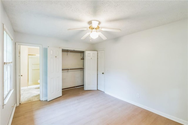 364 Stafford St SW, Marietta, GA 30064 - unfurnished bedroom with light wood-style floors, a textured ceiling, a closet, and a ceiling fan